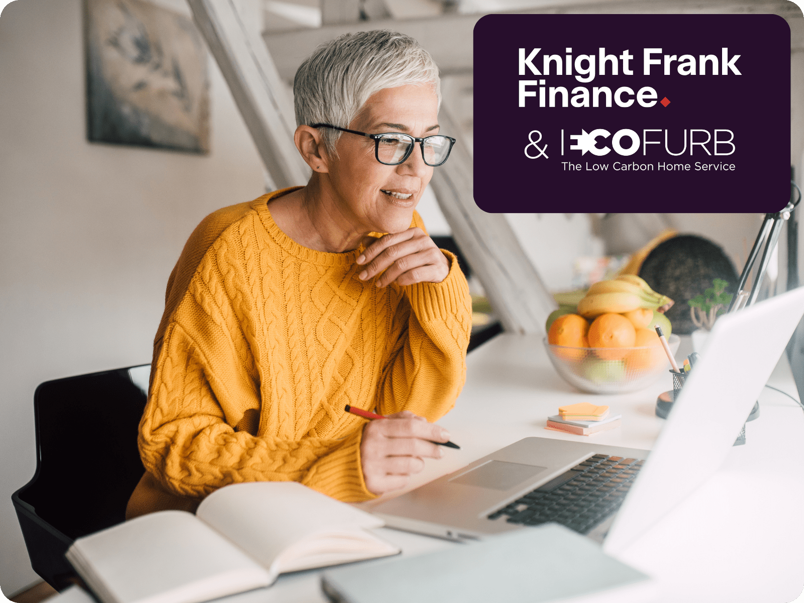 Homeowner with pen, paper and laptop - Knight Frank Finance & Ecofurb